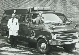 Dr. James V. Warren standing with the Heartmobile